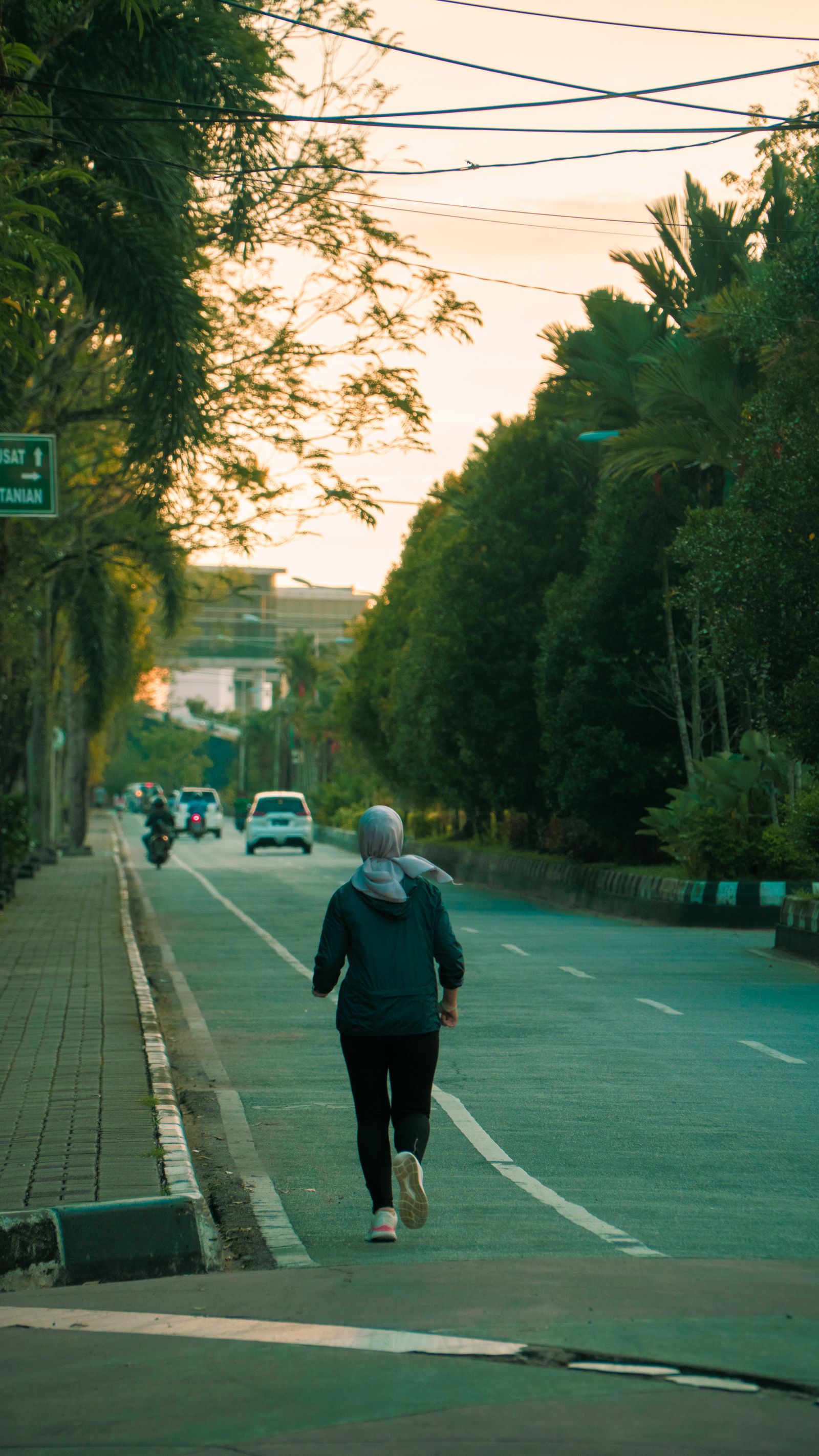 Woman jogging alone on a residential street