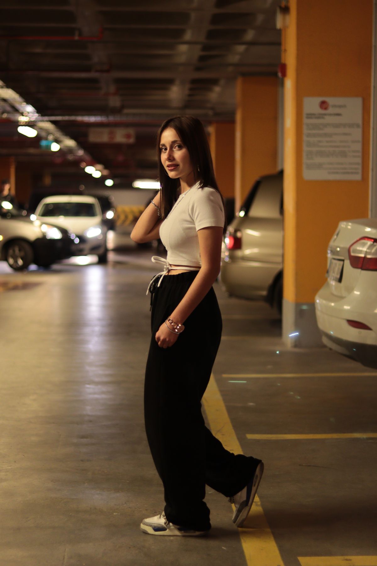 Woman walking through an underground parking garage