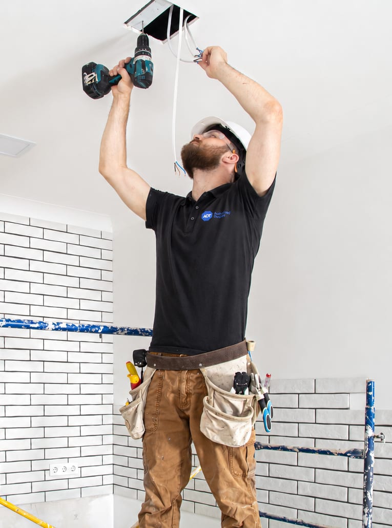 Spartan Smart Security technician installing a system component